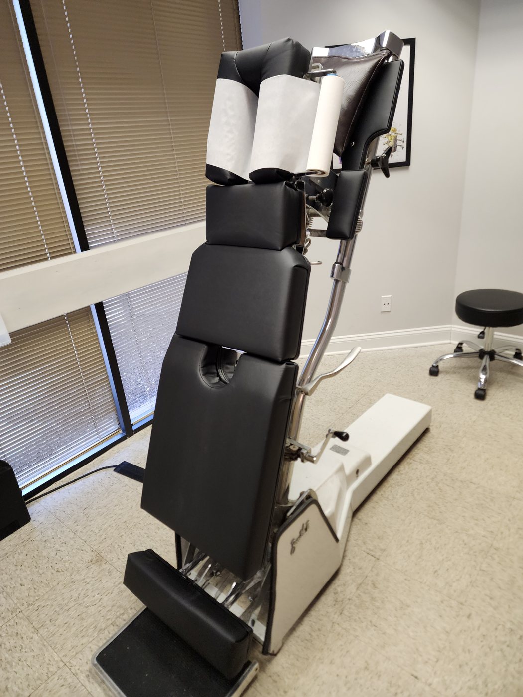 Hi-lo chiropractic table in the upright position at Bonesetters in Chesterfield, MO