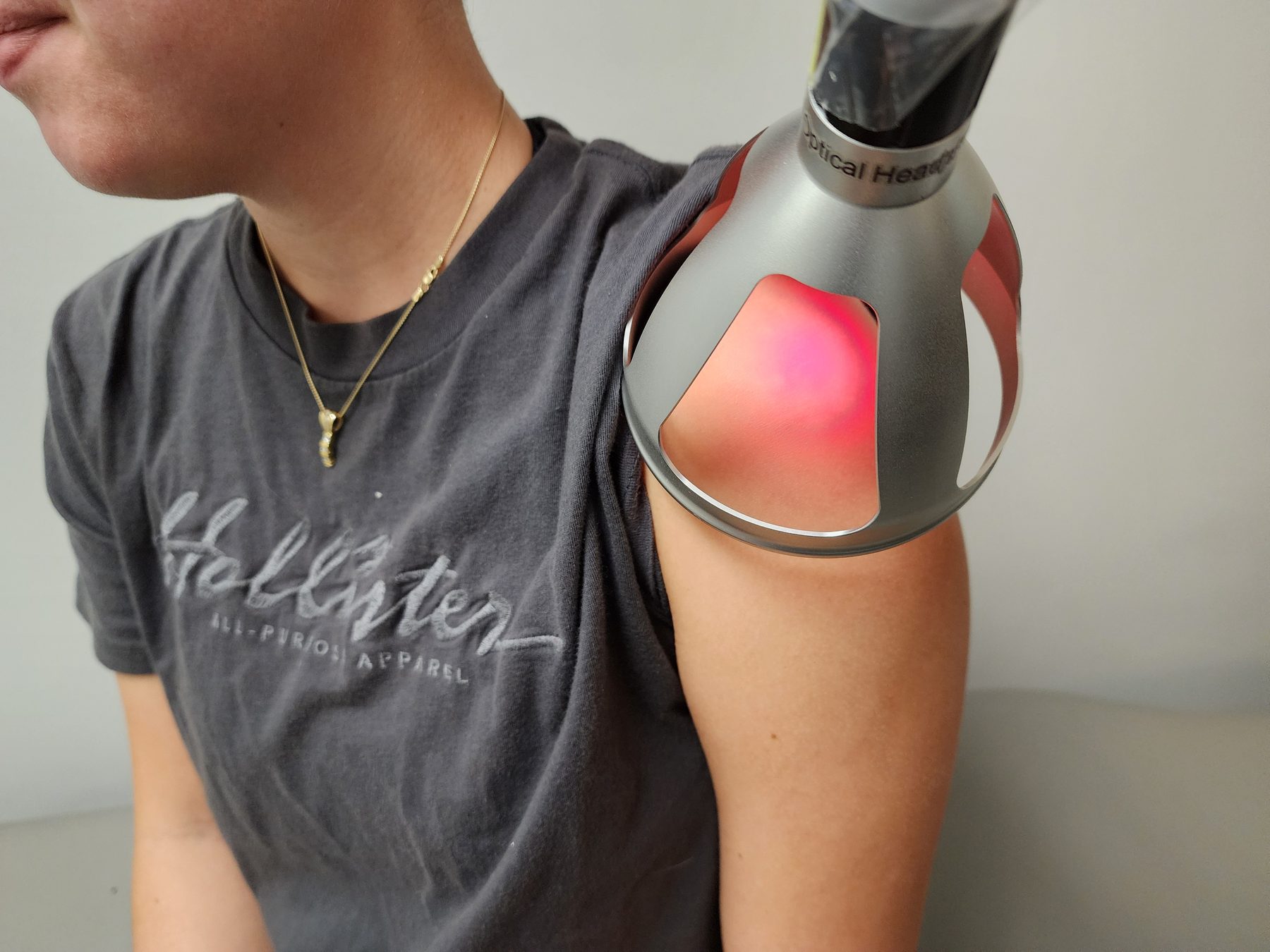 Class IV cold laser applied over a patient's shoulder at Bonesetters in Chesterfield, MO