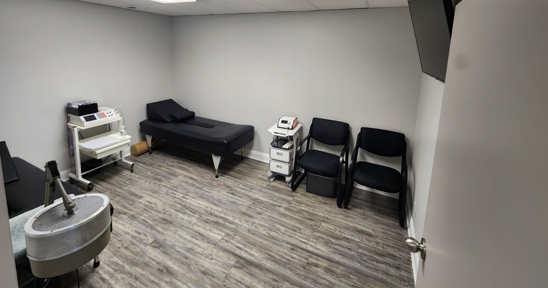 Treatment room with adjusting table at Bonesetters Critical Care Chiropractic in Chesterfield, MO